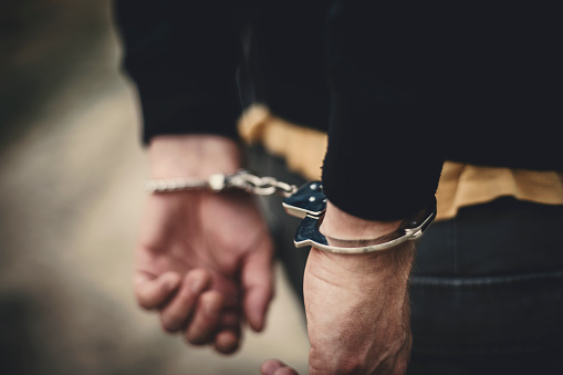 Man in handcuffs behind his back