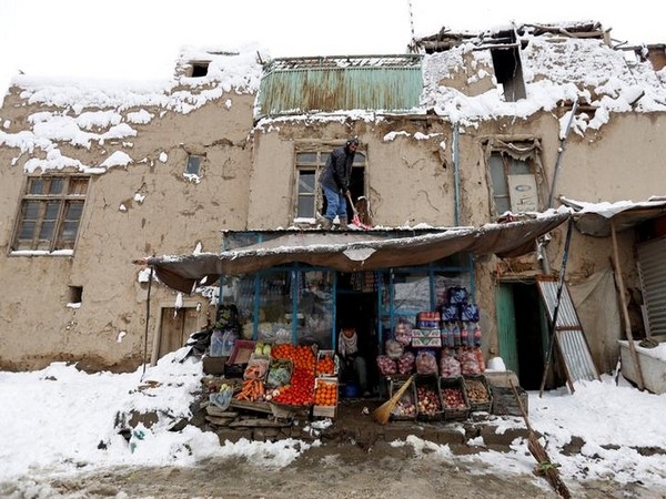 An Afghan man removes snow from his shop during a snowfall in Kabul, Afghanistan February  5, 2017. REUTERS/Mohammad Ismail