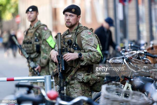 COPENHAGEN, DENMARK - SEPTEMBER 29: Armed soldiers guard the Jewish Synagogue as part of the first deployment in the civilian society on September 29, 2017 in Copenhagen, Denmark. Use of armed soldiers has been restricted to the Royal Guard at the Royal palaces, but following a Government decision of September 8, 2017, armed military units can be deployed in the civilian society in order to relieve the police. Some 170 soldiers have been through training in order to operate in the civilian society. Units have today also been inserted on the Danish - German border. (Photo by Ole Jensen - Corbis/Corbis via Getty Images)