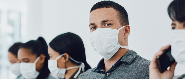 Shot of a group of young people wearing masks in a waiting room