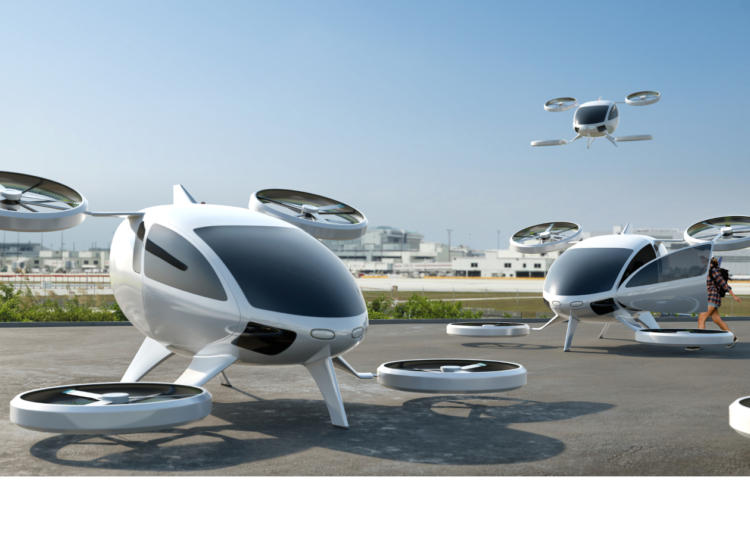 A fleet of generic white electric powered Vertical Take Off and Landing eVTOL aircraft with four rotors parked with airport buildings visible in the background. One has a door open, with a young female passenger about to get on board. Another eVTOL is in flight, coming in to land.